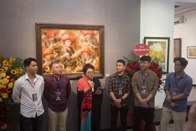 Five participating artists pose for a group photo at the opening ceremony of the exhibition.