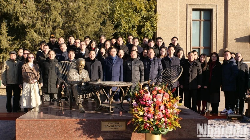 Delegates pose with a statue of President Ho Chi Minh at the Vietnamese Embassy in Beijing.