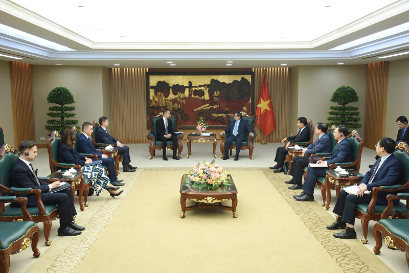 Prime Minister Pham Minh Chinh (R) hosts a reception for Hungarian Minister of Foreign Affairs and Trade Szijjártó Péter in Hanoi on March 19. (Photo: NDO)