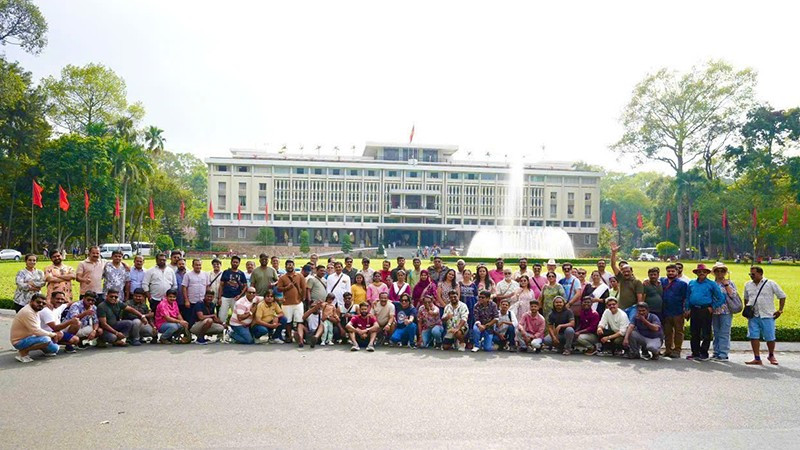 The Indian tourists pose for a group photo in front of the Independence Palace