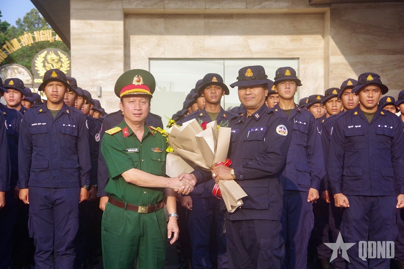 Colonel Nguyen Dinh Chuan, Political Commissar of the Binh Duong provincial Military Command (left), presents flowers to the Cambodian delegation. (Photo: qdnd.vn)