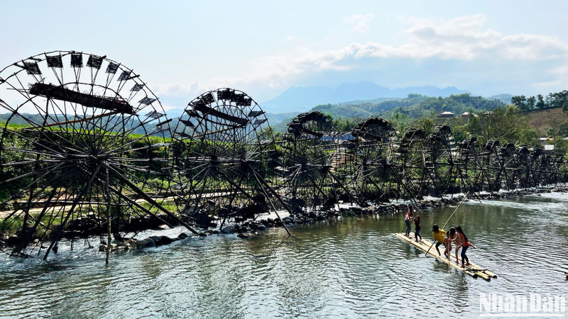 Water wheels continuously spinning to pump water to a higher place for irrigation of the rice during the growing season.