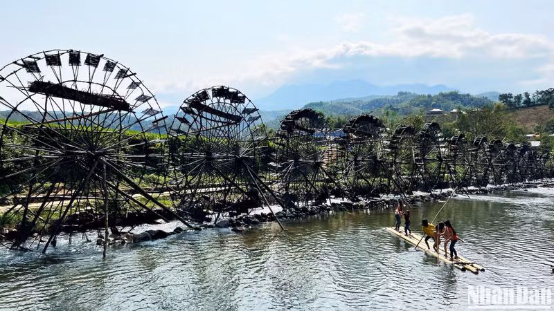 Water wheels continuously spinning to pump water to a higher place for irrigation of the rice during the growing season.
