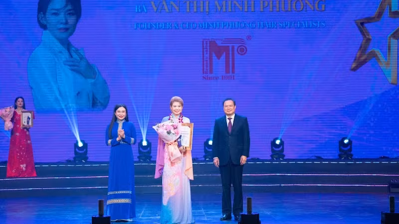 Hairstylist Van Thi Minh Phuong (C) receives the Greatest Hair Artist Prize at the Asia Golden Bauhinia Awards