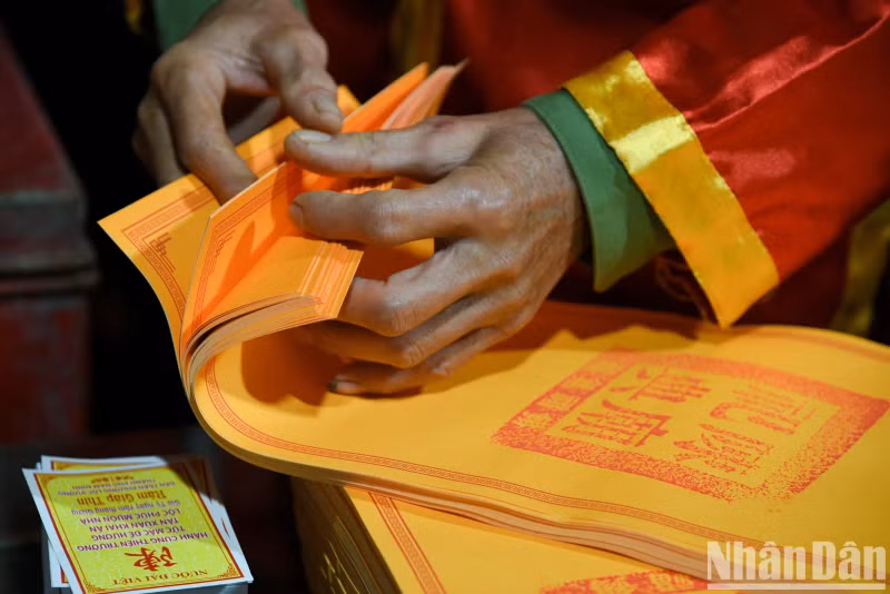 The Tran Temple seal is checked again before distributing it to visitors.