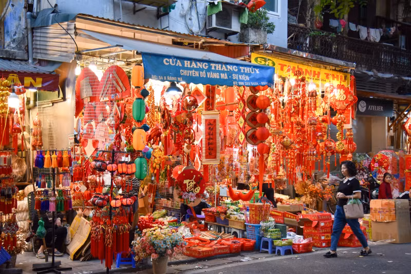 These days, Hang Ma Street is wearing its typical red shirt with traditional decorations for Tet.