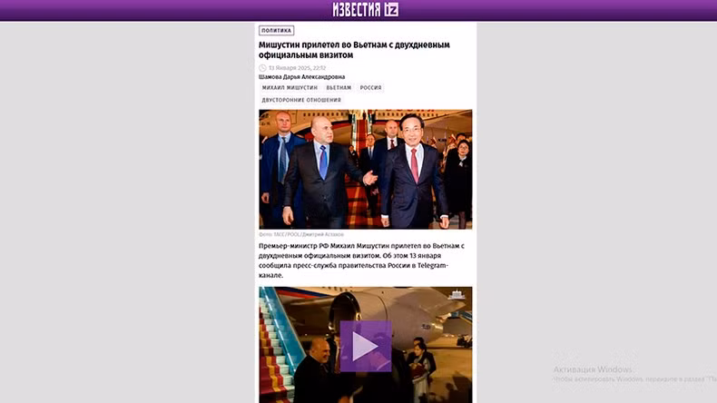 The Izvestia newspaper reports with images of the welcoming ceremony for Russian Prime Minister Mishustin at Noi Bai International Airport. (Screenshot)