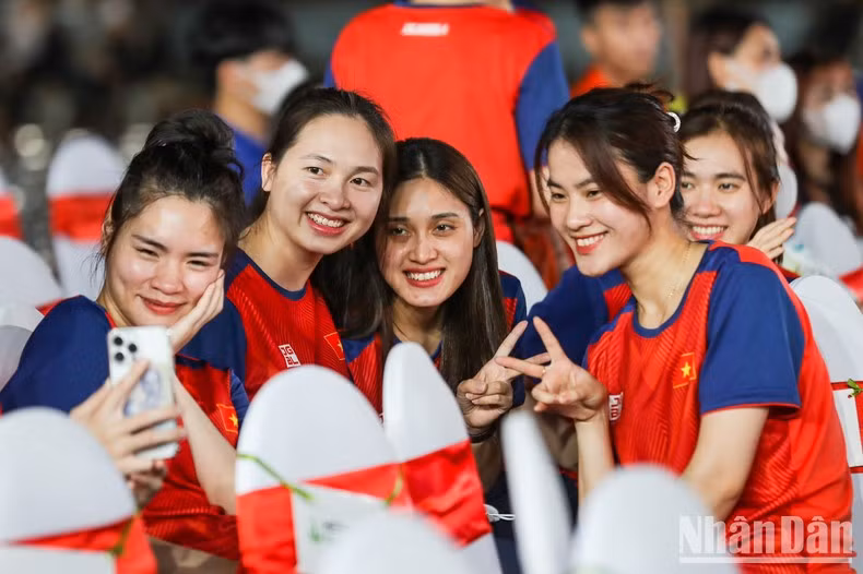 Female athletes cheerfully take selfies.