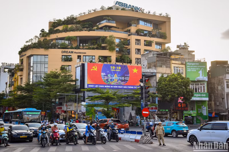 A large poster is placed at O Cho Dua intersection, where a lot of vehicles pass. A large poster is placed at O Cho Dua intersection, where a lot of vehicles pass.