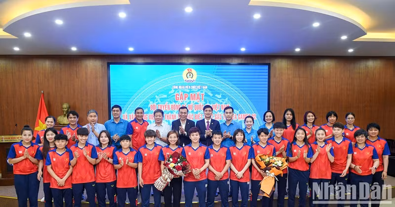 The delegates, Vietnamese women’s football team and athlete Nguyen Thi Oanh pose for a photo.