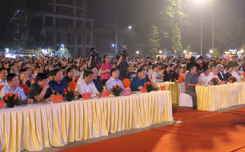 Other delegates attend the opening ceremony for the display.