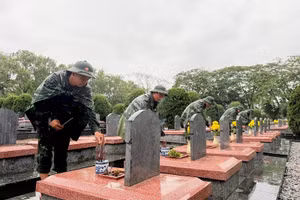 Soldiers of the Dien Bien Provincial Military Command offer incense at the graves of fallen soldiers at Doc Lap Martyrs' Cemetery.