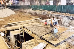 Contractors work overnight on flood-control projects in Ha Noi.