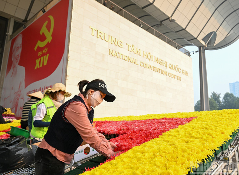 Workers are busy completing the final decorative items.