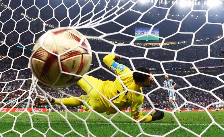 Argentina's Lionel Messi scores a penalty during the penalty shootout past France's Hugo Lloris. REUTERS/Kai Pfaffenbach