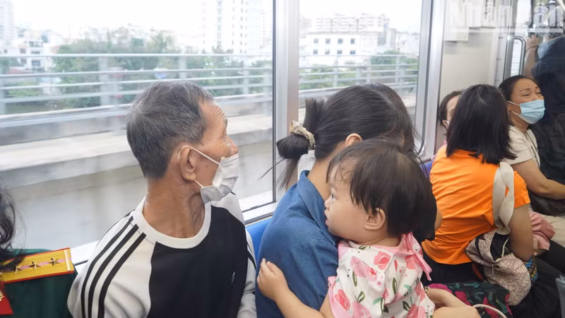 A kid looks outside the metro train window. A kid looks outside the metro train window.