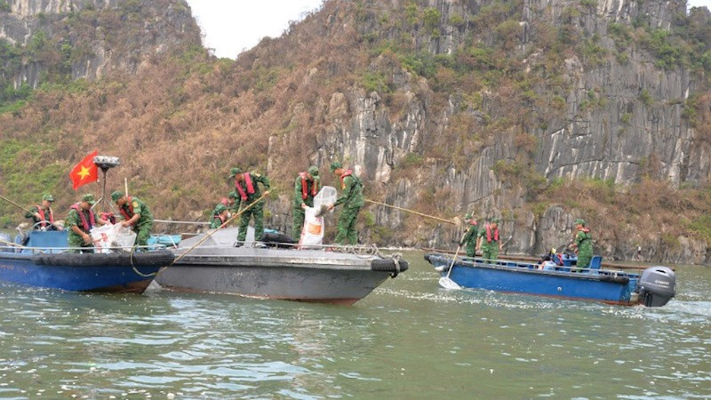 Members of the Quang Ninh border guard collects garbage in Ha Long Bay.