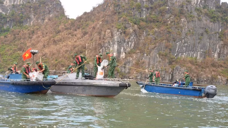 Members of the Quang Ninh border guard collects garbage in Ha Long Bay.