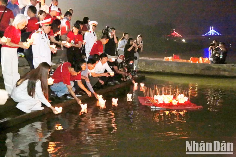 Lanterns are released into the Thach Han River to commemorate fallen soldiers.