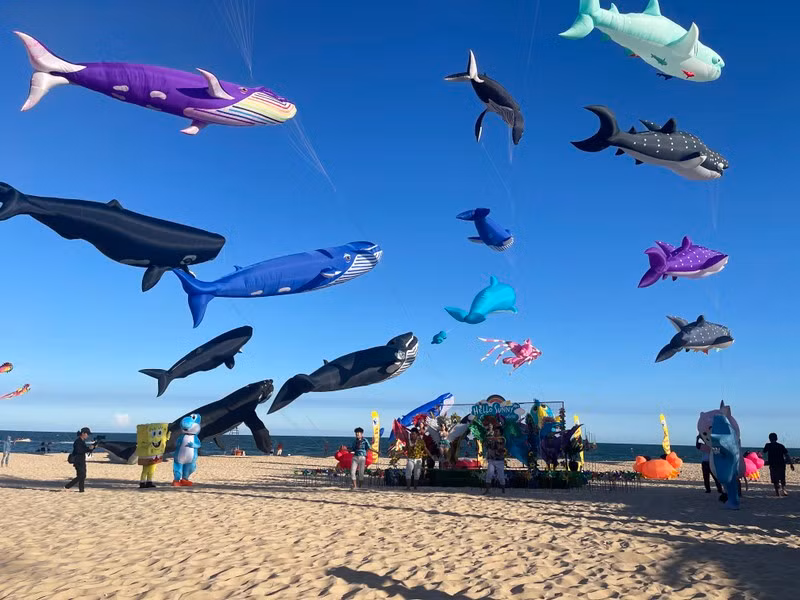 Giant kites shaped like sea creatures are flown at the festival.