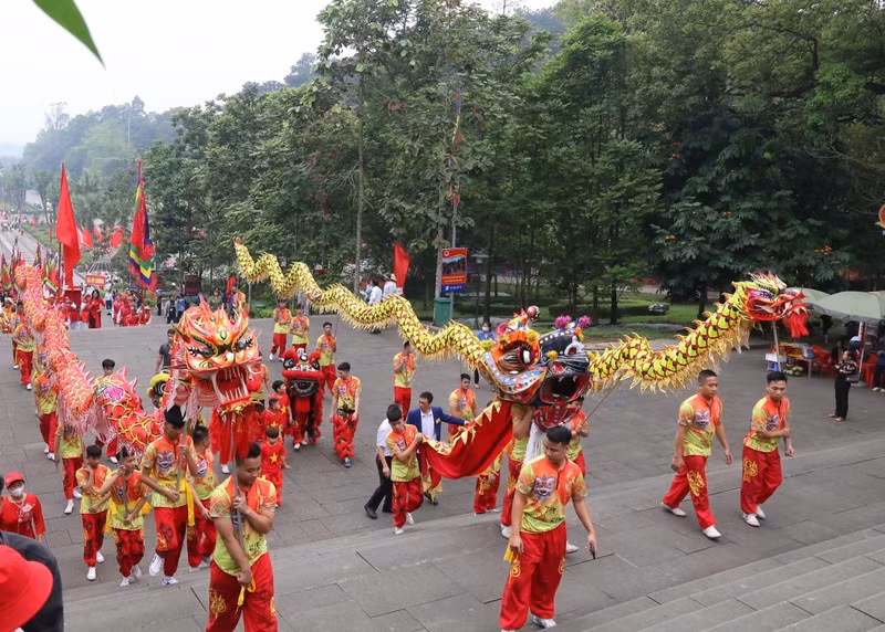 The procession is led by a team of lion and dragon dancers.