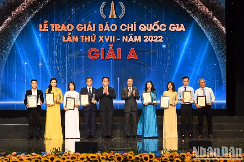 President Vo Van Thuong and Head of the Central Commission for Communication and Education Nguyen Trong Nghia presents the A prizes to the winning journalists.
