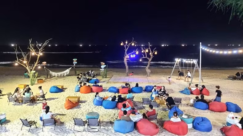 Tourists enjoy a cool night by the beach in Quang Binh.