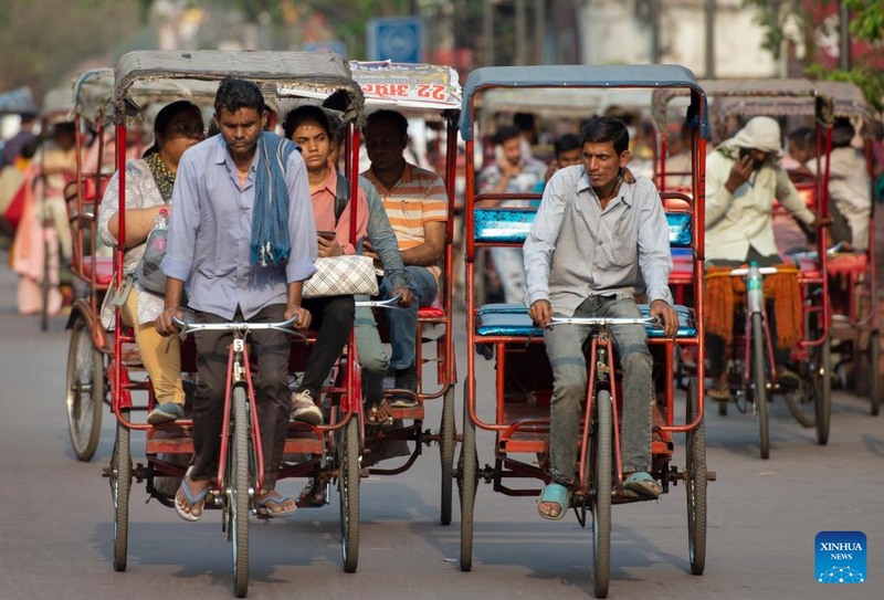 People ride rickshaws at a market place in New Delhi, India, on April 26, 2023. (Photo: Xinhua)