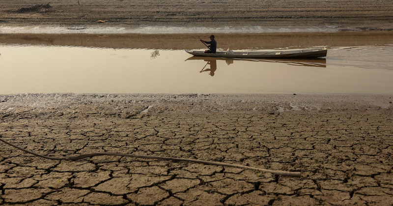 A person on a boat navigates on Puraquequara Lake, which has been affected by drought, in Manaus, Brazil, October 6, 2023. (Photo: Reuters)