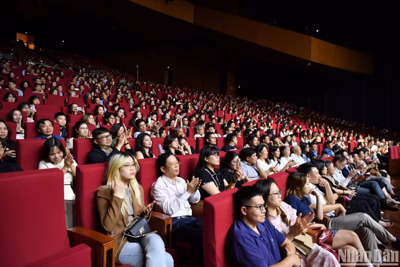 The audience at the National Convention Centre enjoy the performance by Bond.