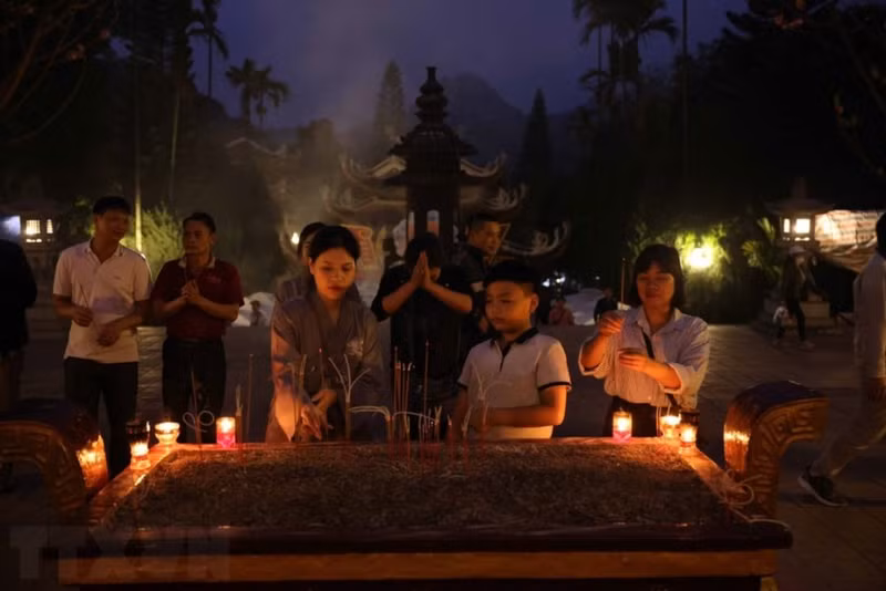 Pilgrims and visitors offer their incense ahead of the opening of the Perfume Temple Festival.