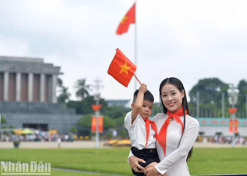 A boy and his mother pose for a photo at Ba Dinh Square.