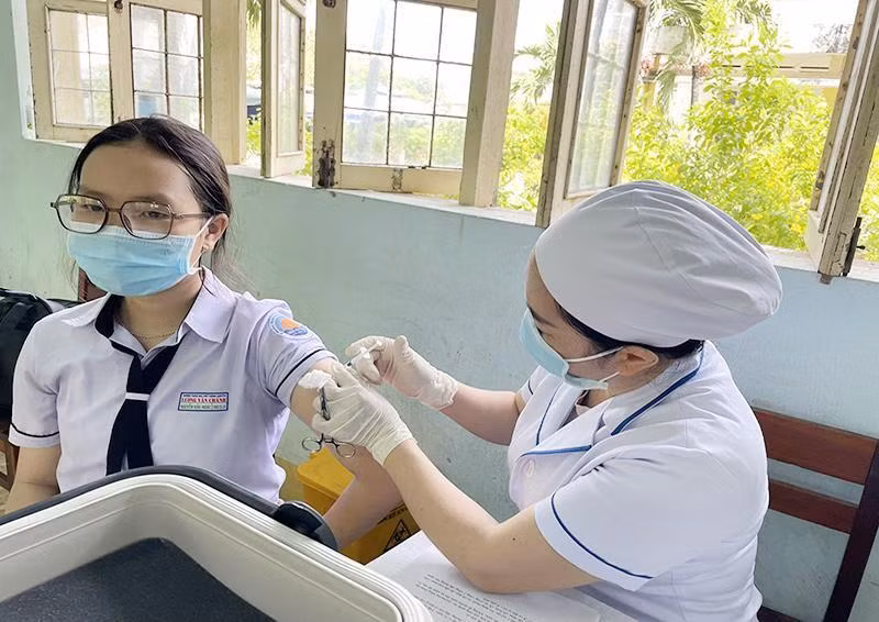 A pupil is vaccinated against COVID-19.