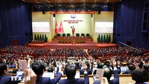 Delegates vote to adopt the resolution of the 14th National Congress of the Communist Party of Viet Nam. (Photo: VNA)
