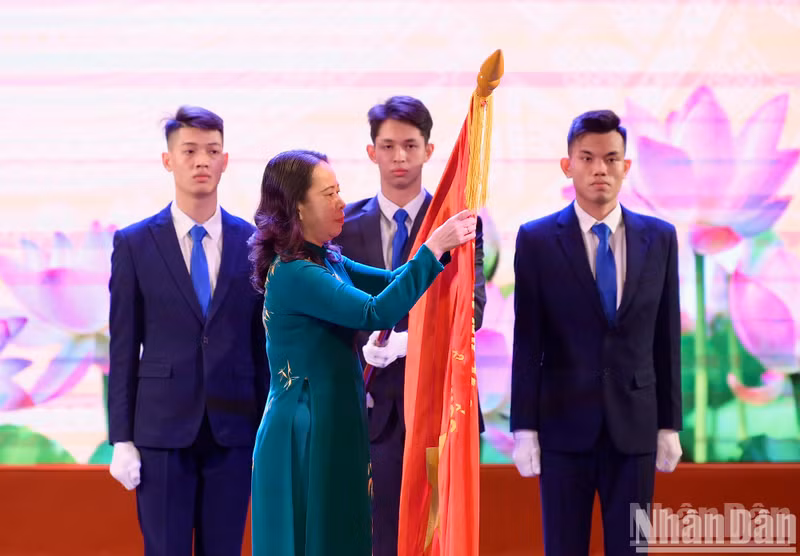 Vice President Vo Thi Anh Xuan affixing the third-class Labour Order to representatives of the company’s leadership and staff. (Photo by DAI GIANG)