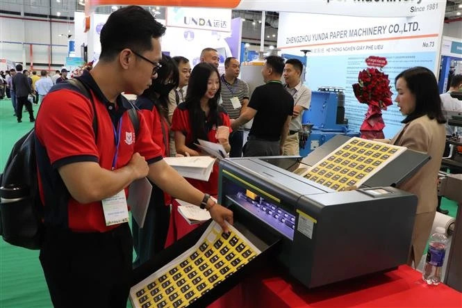 Visitors learn about stamp printing technology at the Viet Nam International Paper and Packaging Exhibition 2025 (Photo: VNA)
