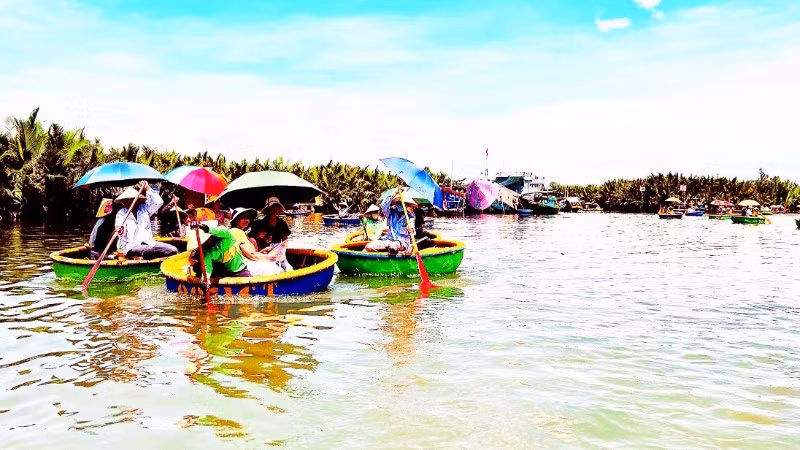 Visitors experience the Bay Mau nipa palm forest tourist site in Cam Thanh Commune, Hoi An.