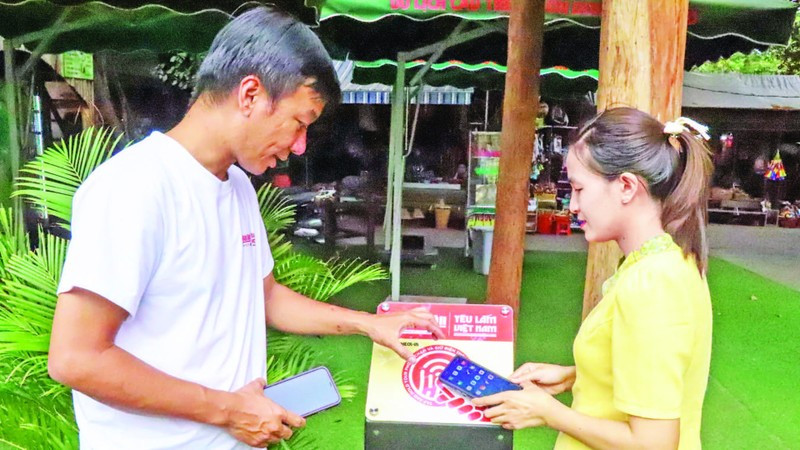 A visitor scans an NFC-enabled board from the “Love Vietnam So Much” project at the Buon Don Suspension Bridge Tourism Centre, Dak Lak Province. (Photo: KIM BAO)