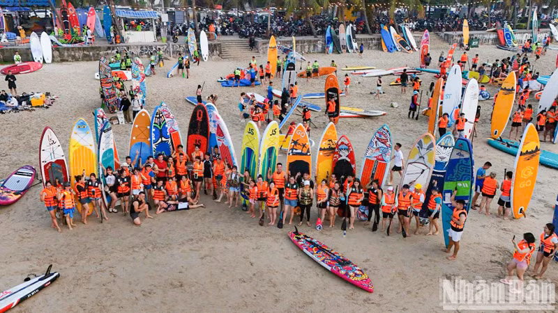 Visitors take commemorative photos before launching into the waves.