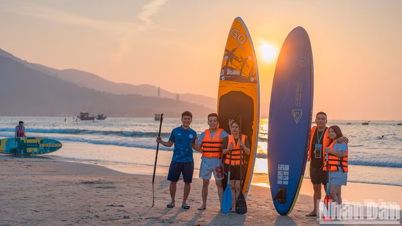 A SUP rental operator poses for a photo with a customer.