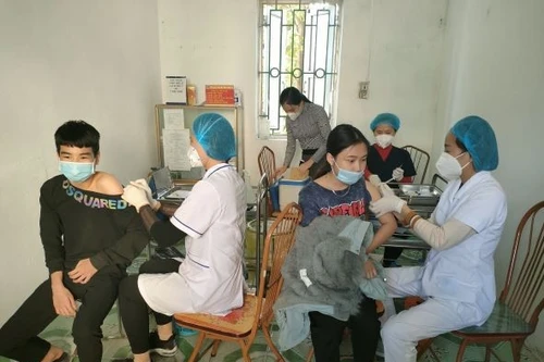 Medical staff administer vaccinations to students at a provincial school in Hung Yen.