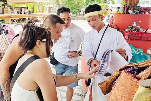 Sales staff advise and introduce products to tourists. (Photo: NAM ANH)