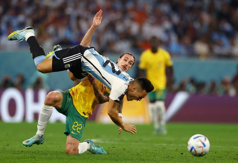 Argentina's Lautaro Martinez in action with Australia's Jackson Irvine. REUTERS/Kai Pfaffenbach