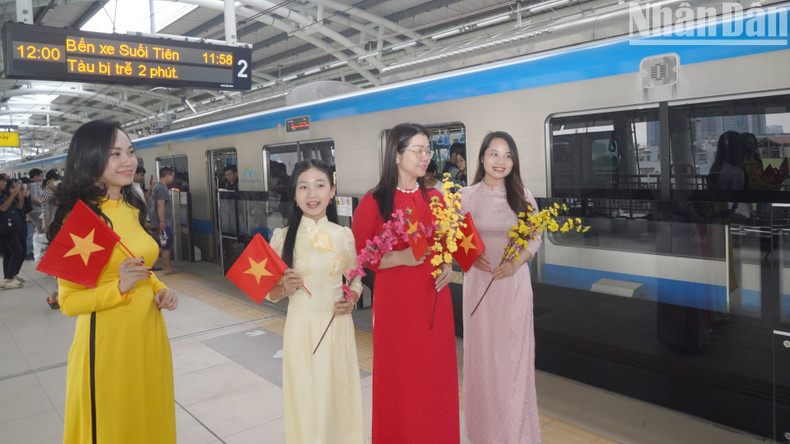 Women in ao dai pose for photos at Van Thanh Station.