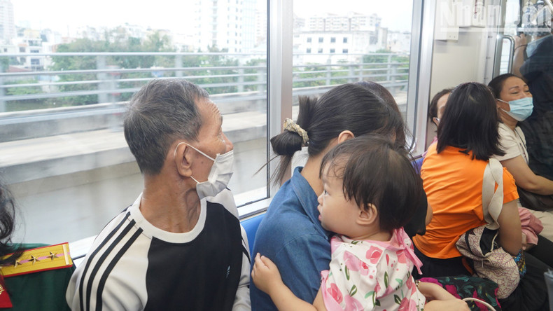 A kid looks outside the metro train window.