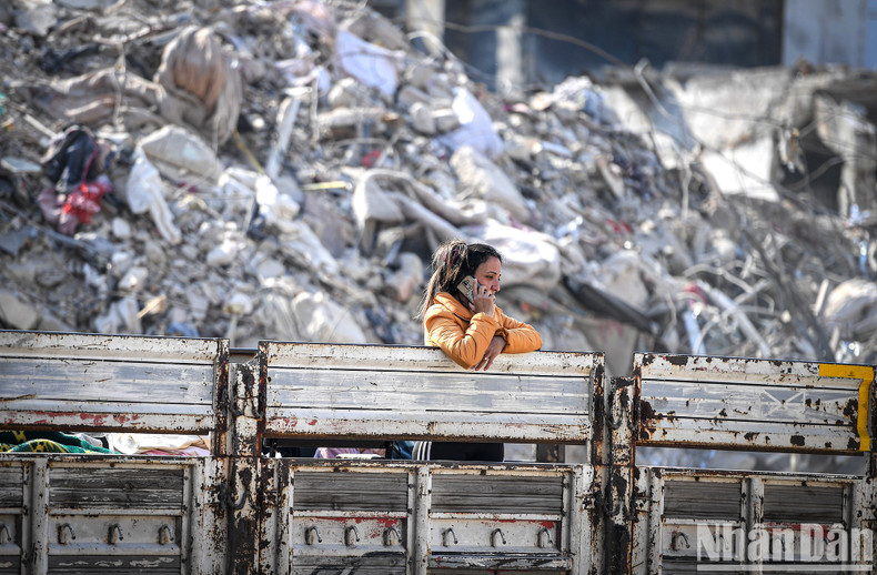 A survivor is making a phone call, with terror remaining on her face. A survivor is making a phone call, with terror remaining on her face.