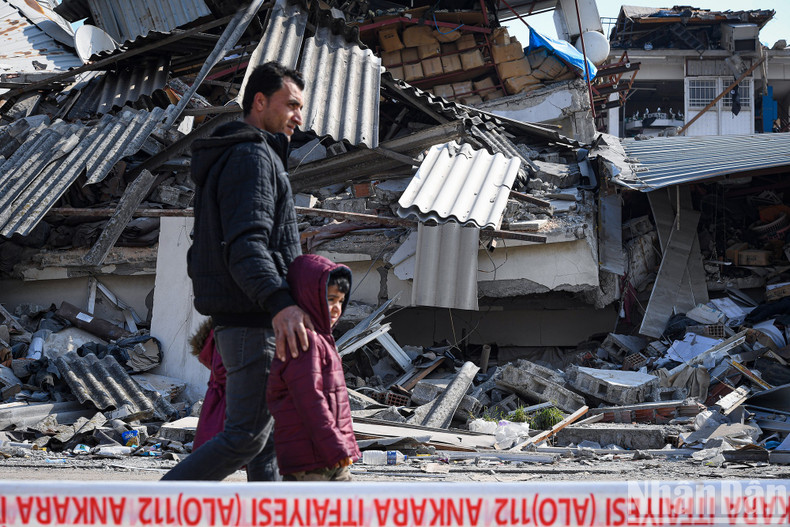 A father and his two children walk in the ruined city. A father and his two children walk in the ruined city.