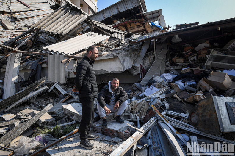 Two men have a conversation by the ruins. Two men have a conversation by the ruins.