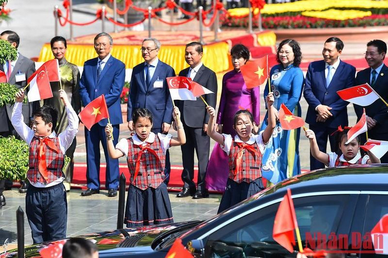 Vietnamese children welcome visiting Singaporean President Halimah Yacob.