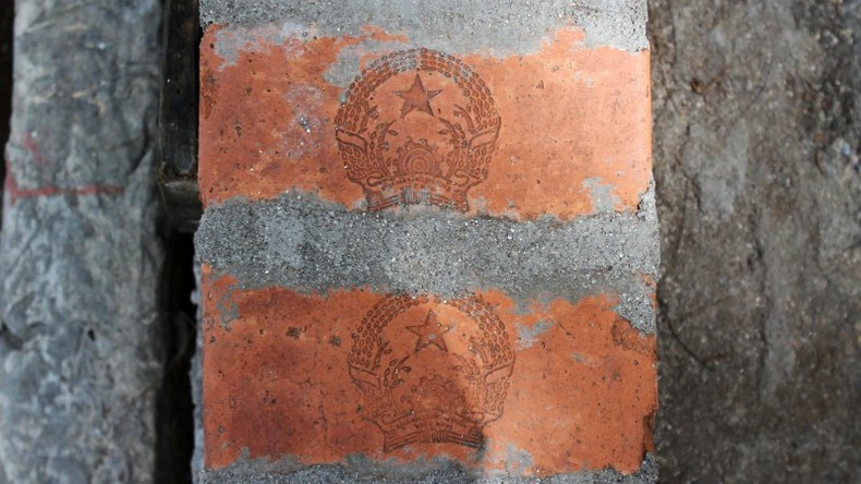 The sacred national emblem is imprinted on the red brick walls.